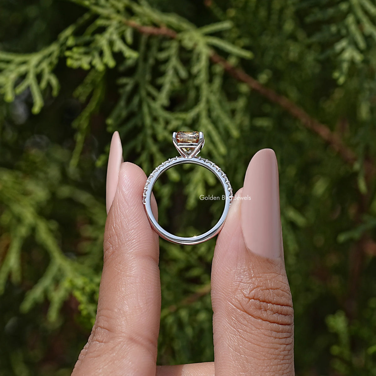 Cushion cut moissanite engagement ring in sterling silver, shown on fingers
