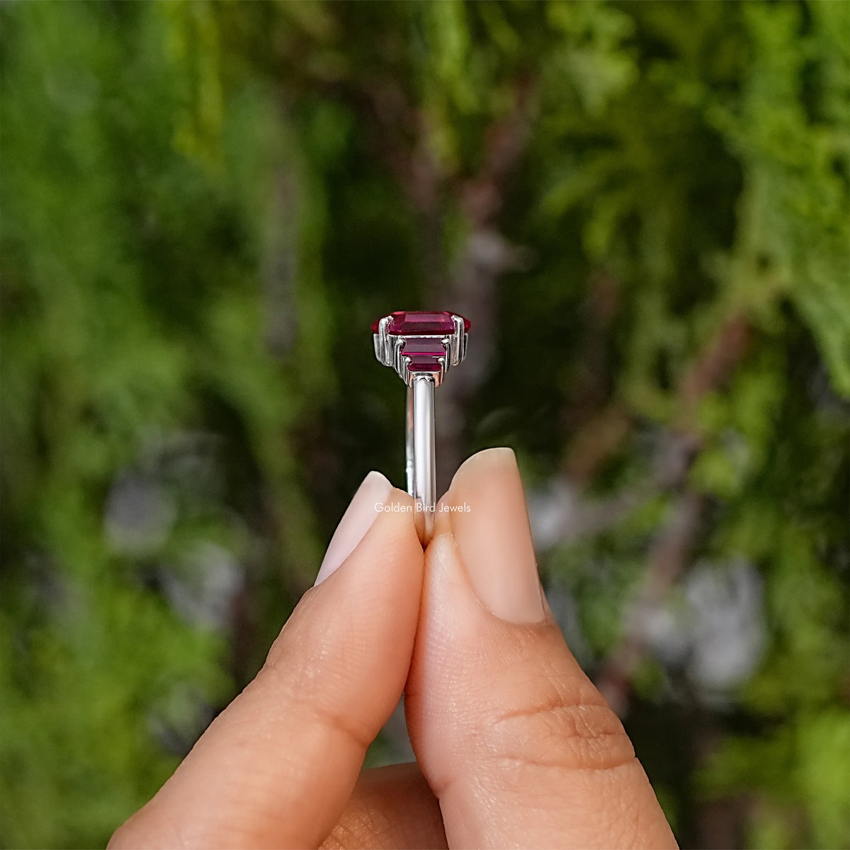 Ruby red hexagon-cut gemstone ring, side prongs and baguette stones visible from top