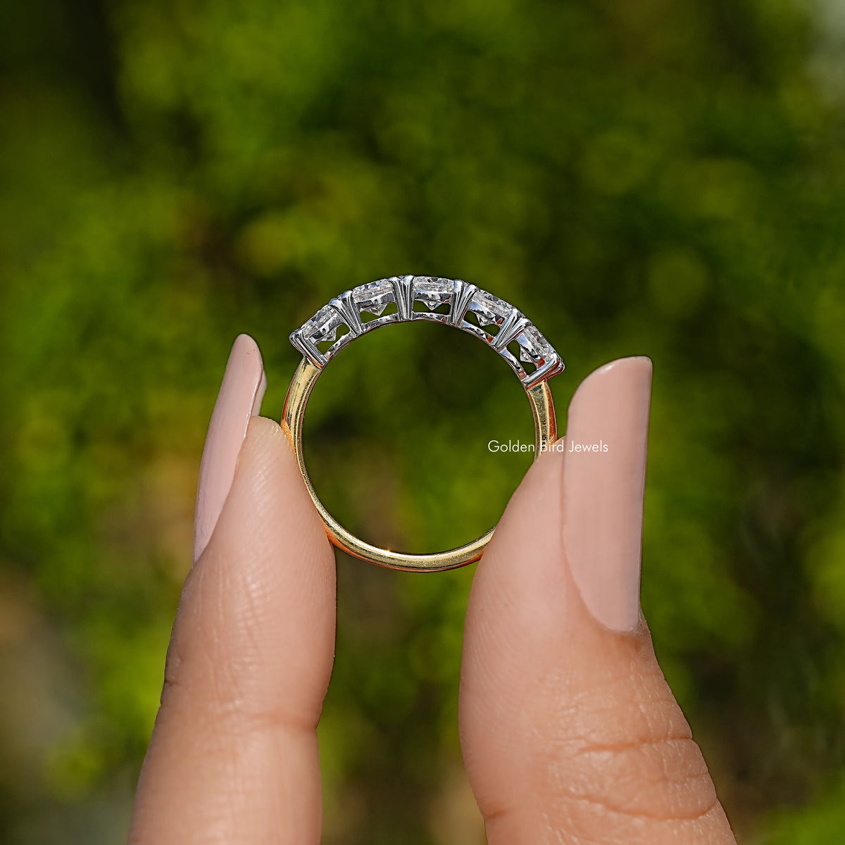 Five-stone round moissanite wedding band, side view with prong-set stones, sterling silver