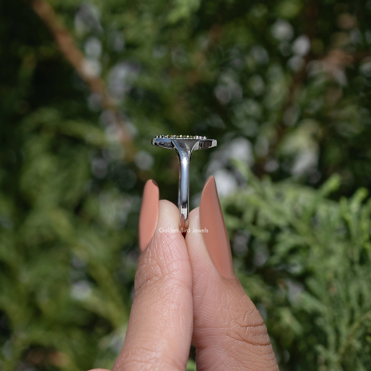 Silver-tone ring band with prong setting, underside view of oval gemstone signet