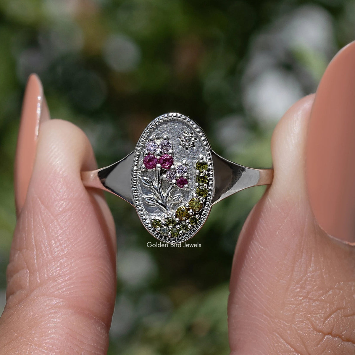 Silver-tone oval floral signet ring with marquise and round pink gemstones in border