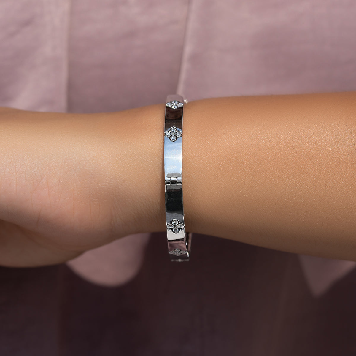 Silver bangle bracelet with round lab-grown diamonds in floral motifs
