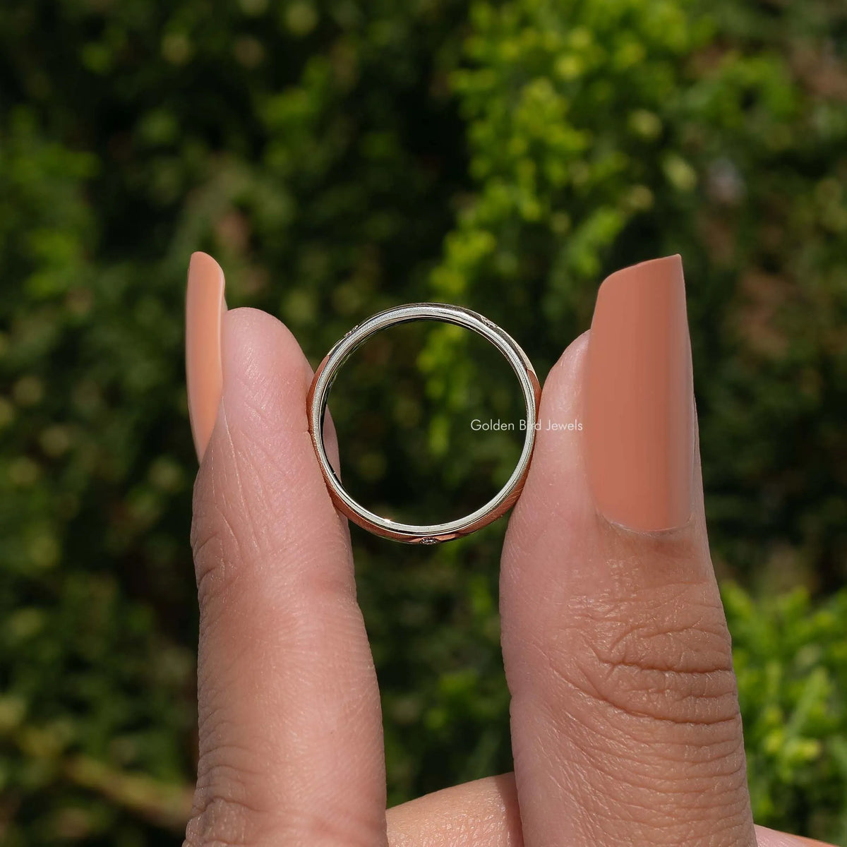 Flush-set diamond eternity band ring on hand, top view of circular band