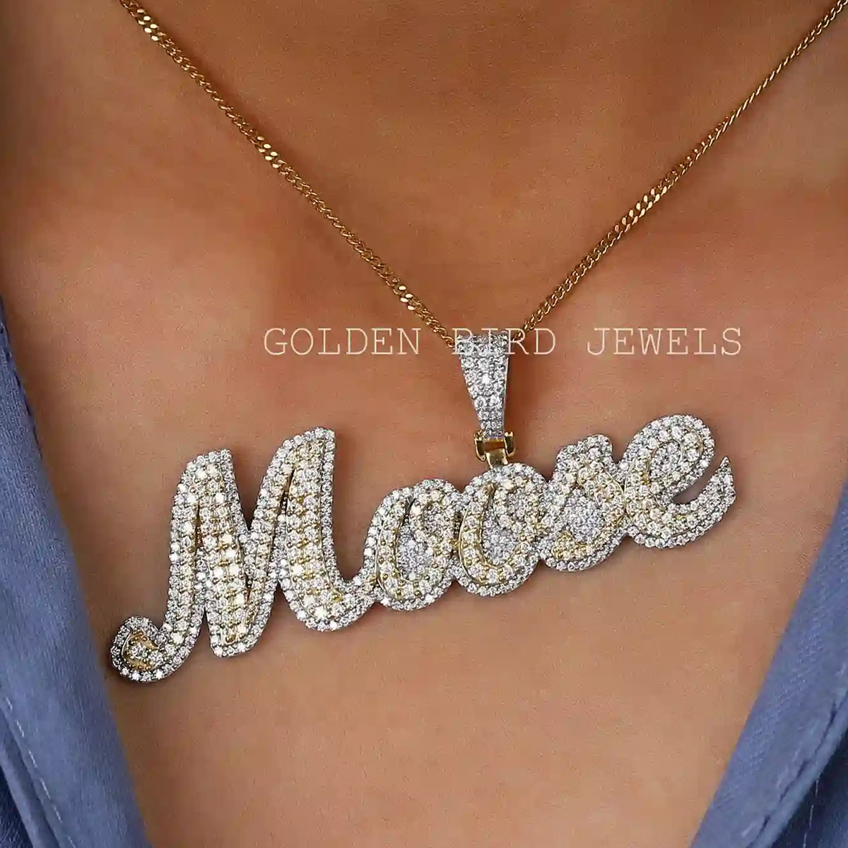 Round moissanite letter pendant with gold-toned chain, sparkling cursive 'M'.