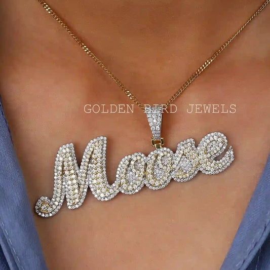 Round moissanite letter pendant with gold-toned chain, sparkling cursive 'M'.