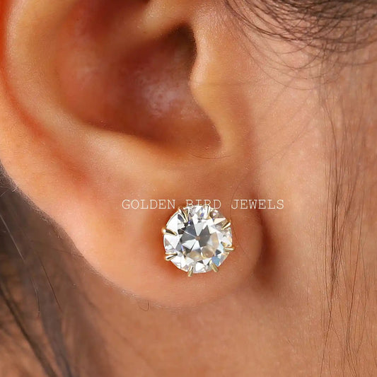 Round moissanite stud earring with prong-set round clear stone, shown on ear