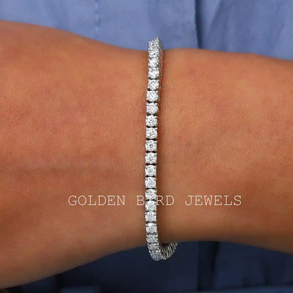 Silver moissanite tennis bracelet with round-cut stones, close on wrist