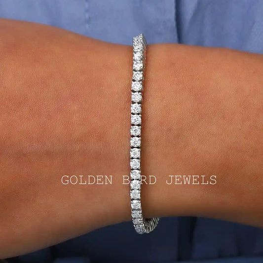 Silver moissanite tennis bracelet with round-cut stones, close on wrist