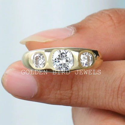 Three-stone cushion-cut moissanite men's ring with gold-tone band and three bright stones