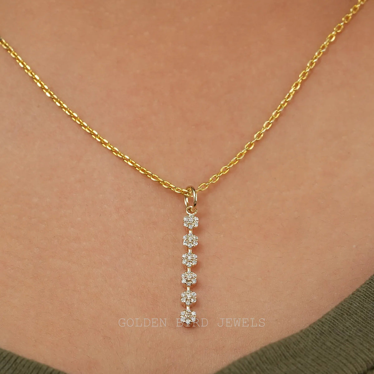Gold-tone round moissanite cluster floral pendant on chain, five small stones vertical
