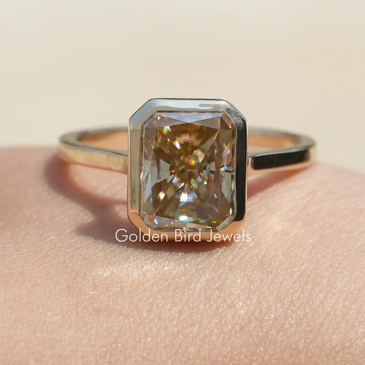 Radiant-cut moissanite solitaire ring with rectangular gold center stone