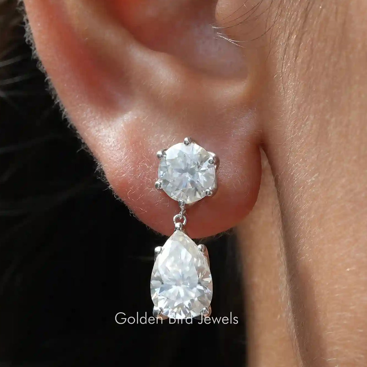 Moissanite dangle earrings with round and pear cut clear stones, silver-tone setting