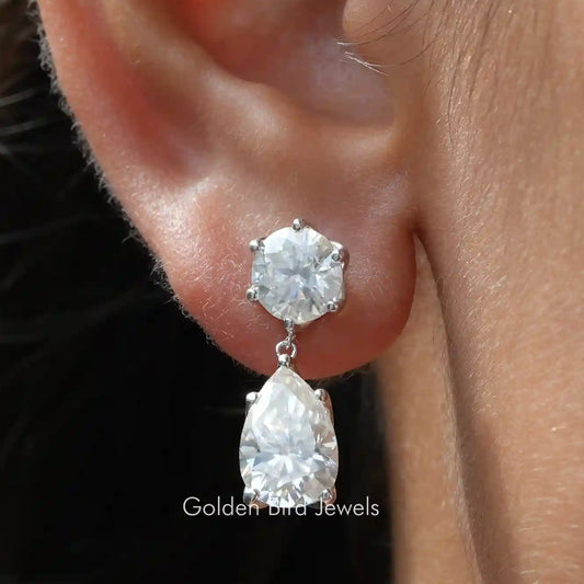 Moissanite dangle earrings with round and pear cut clear stones, silver-tone setting