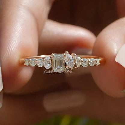 Gold-tone half eternity ring with central emerald-cut stone and side round stones