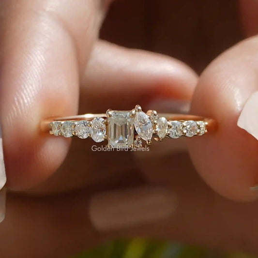 Gold-tone half eternity ring with central emerald-cut stone and side round stones