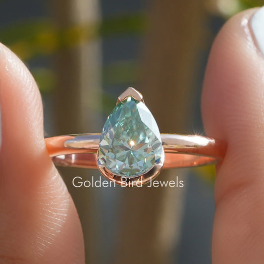 Gold-tone pear cut solitaire ring with V-prong setting and teardrop gemstone