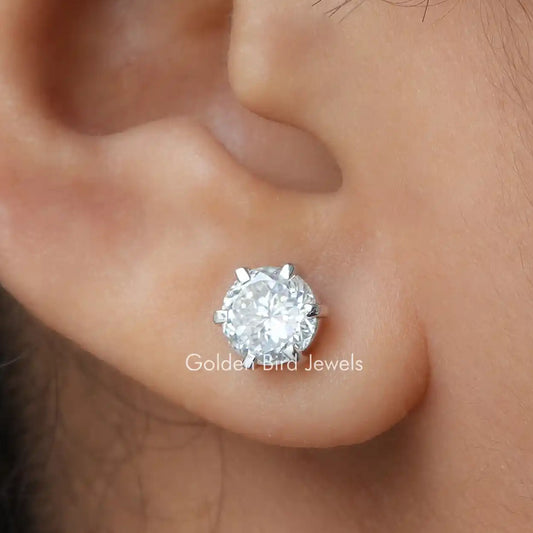 Round moissanite stud earring in silver with a faceted center stone