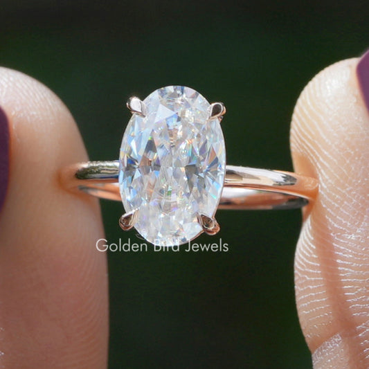 Oval moissanite ring with crushed-ice sparkle, four-prong setting on silver band
