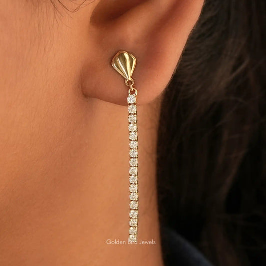 Gold-tone tennis drop earrings with round colorless stones, teardrop top
