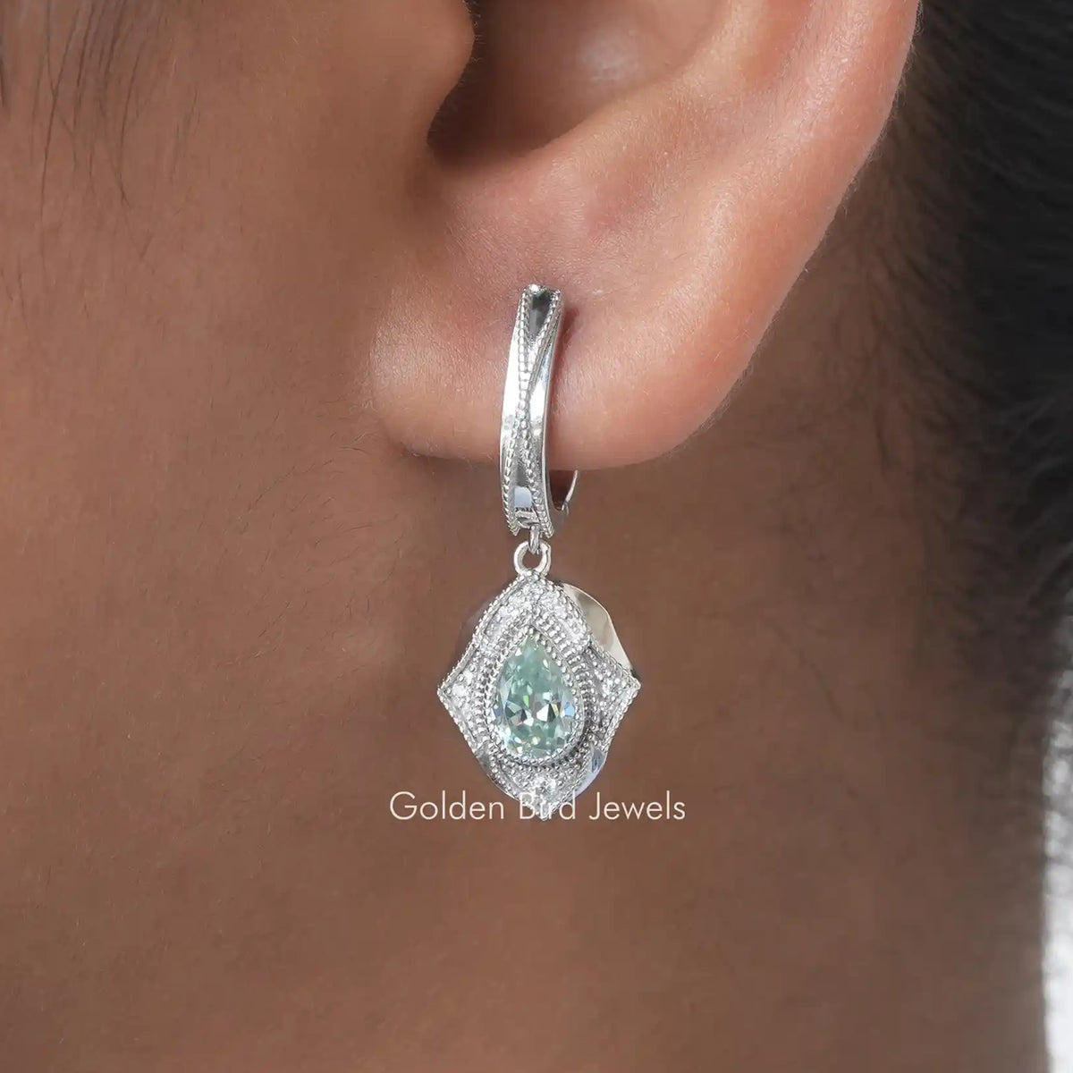 Silver dangle earring with pear-cut blue moissanite