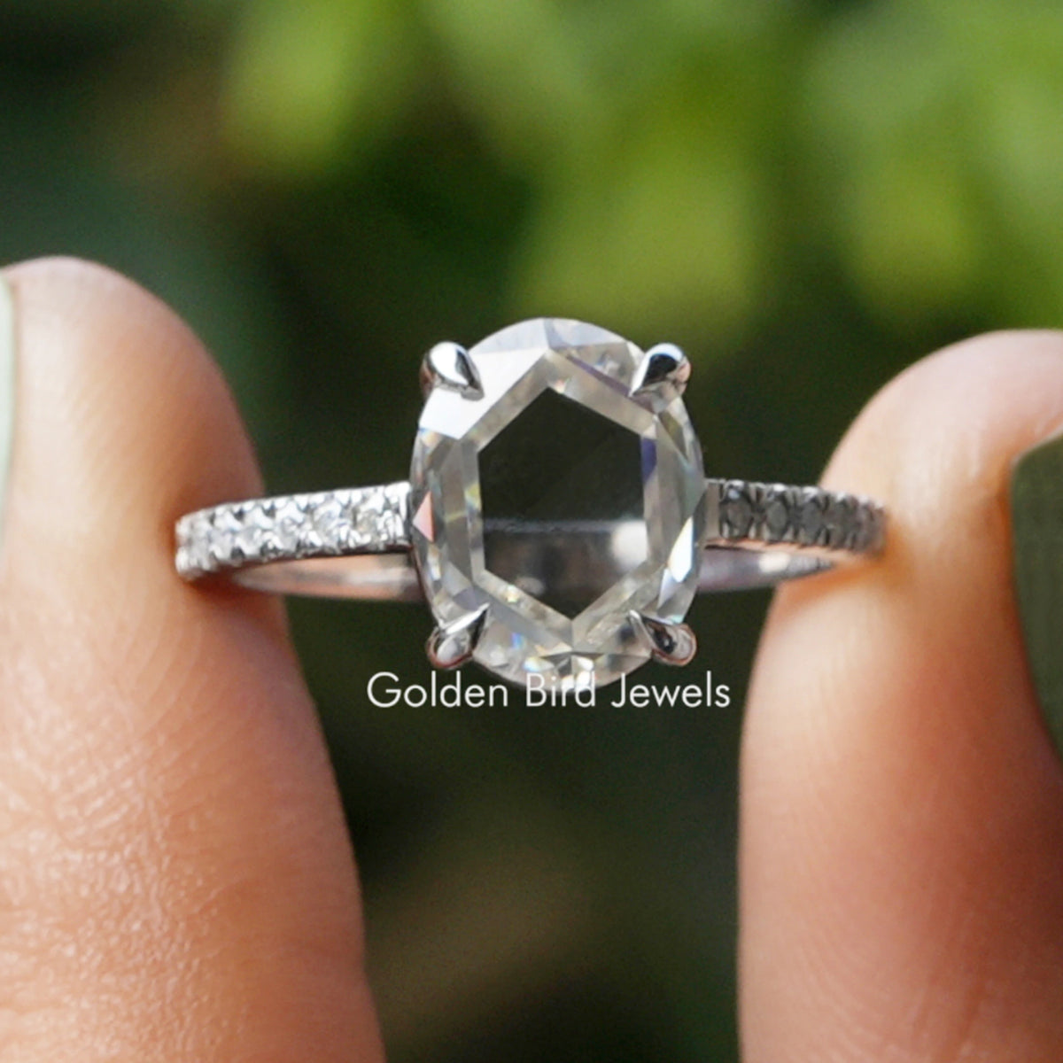 Oval-cut moissanite accent ring with prong-set clear center stone and slim band