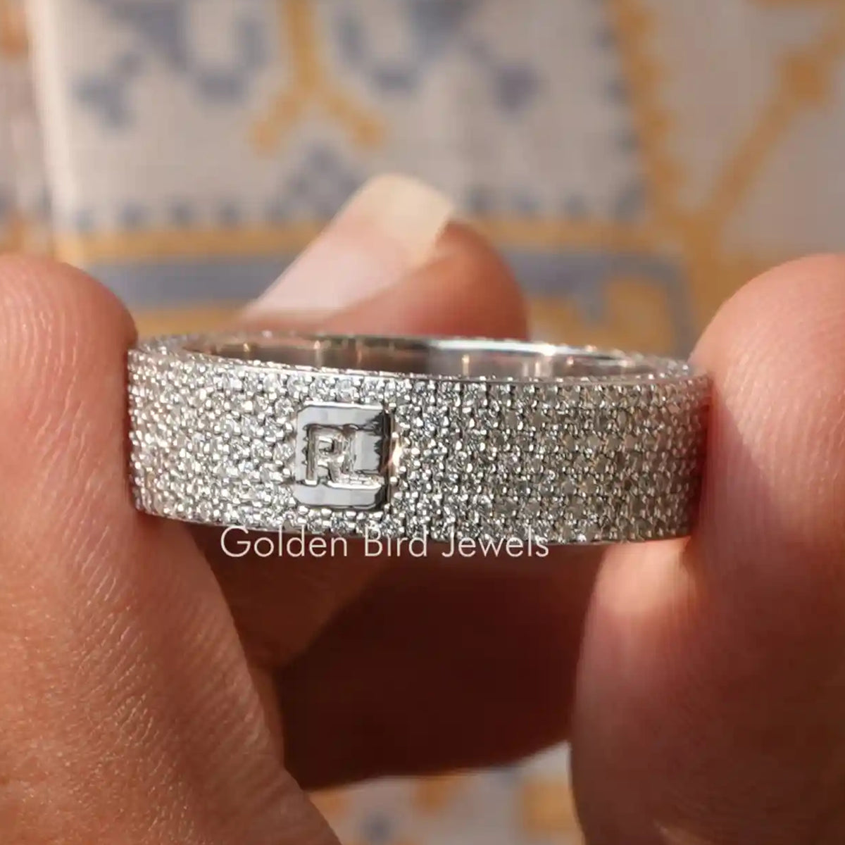 Silver eternity wedding band with round diamonds and square engraved centerpiece