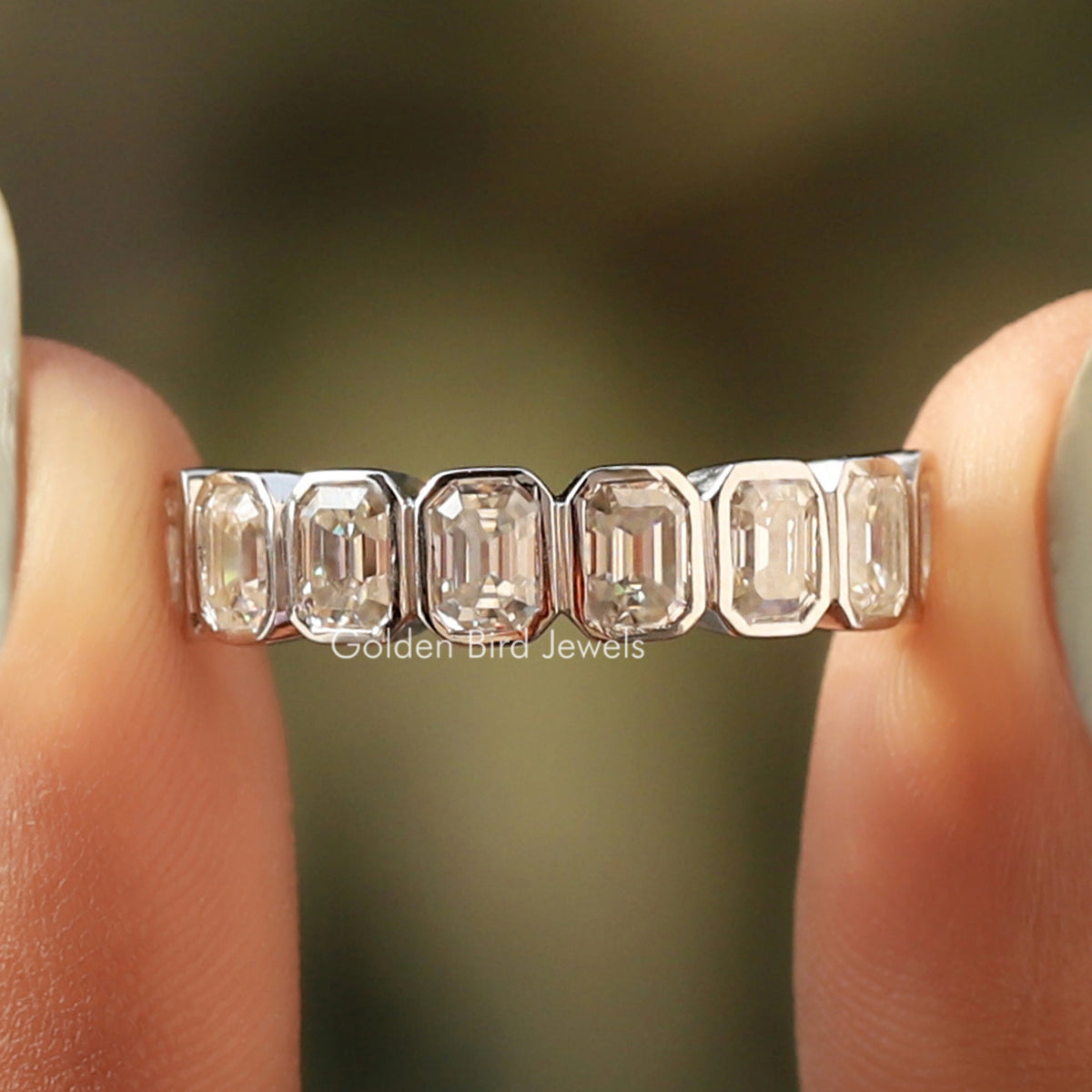 Silver half-eternity band featuring emerald-cut clear stones in a row, close-up