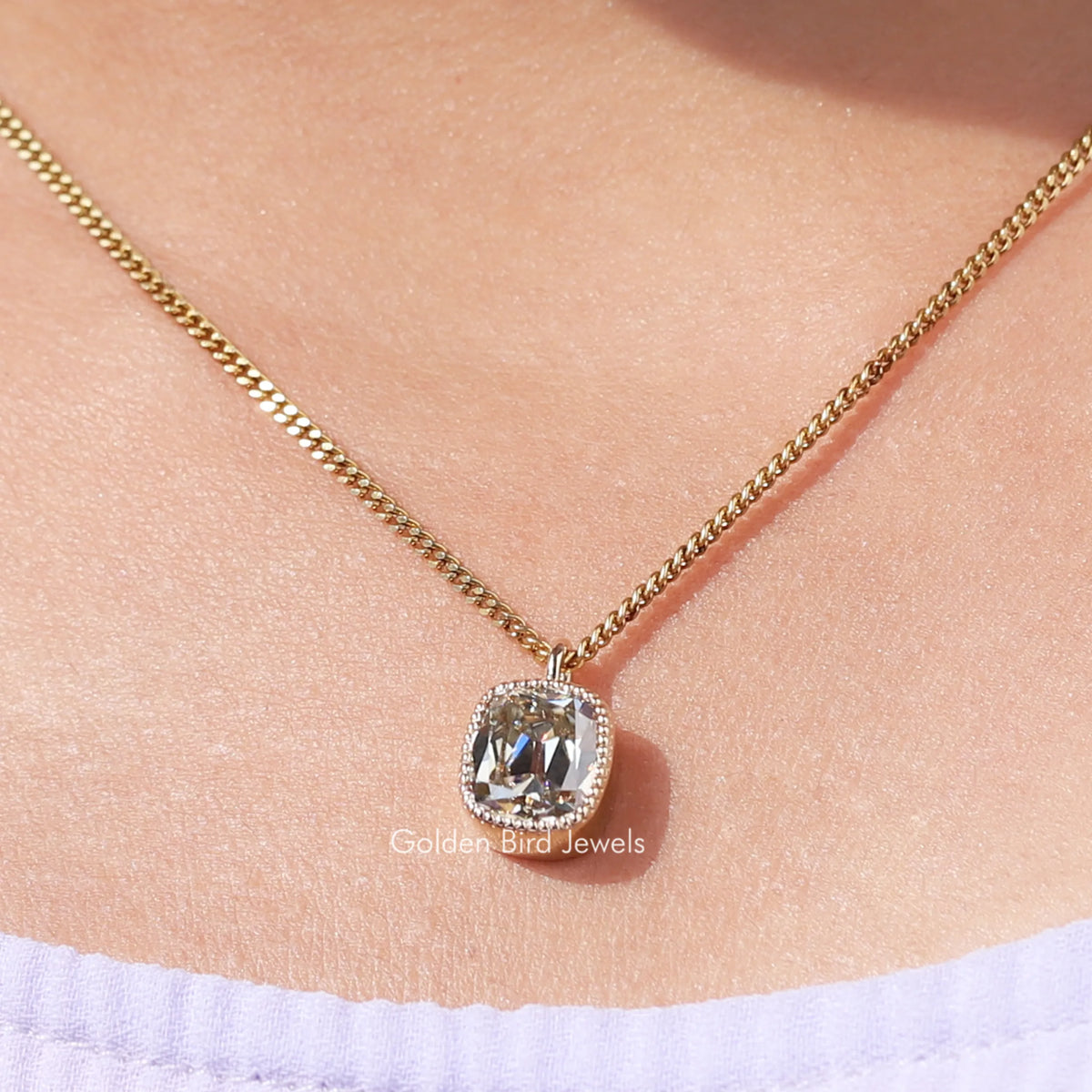 Gold-tone chain pendant with cushion-cut bezel-set moissanite center stone