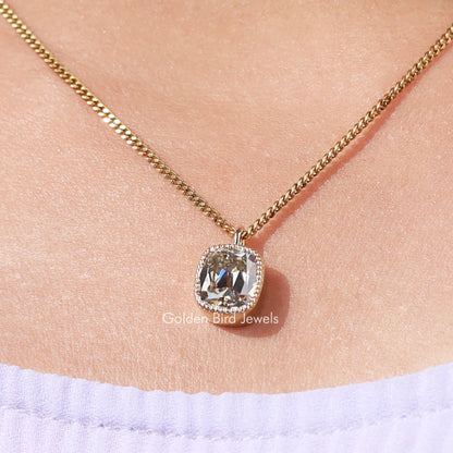 Gold-tone necklace pendant with cushion-cut bezel-set moissanite, small square setting