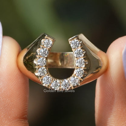 Gold horseshoe engagement ring with round moissanite stones in U-shaped bezel setting