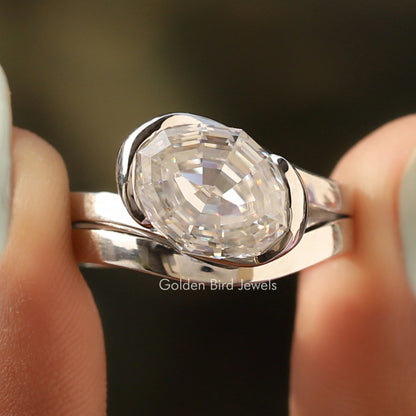 Oval moissanite bypass ring, curved polished silver band with bezel-set stone