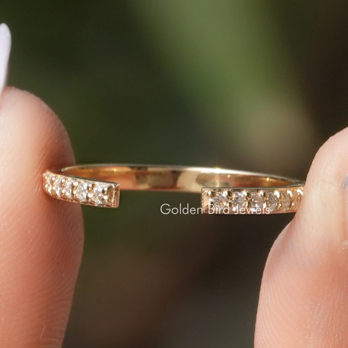 Round Shape Moissanite Open Cuff Engagement Ring Held Between Fingers