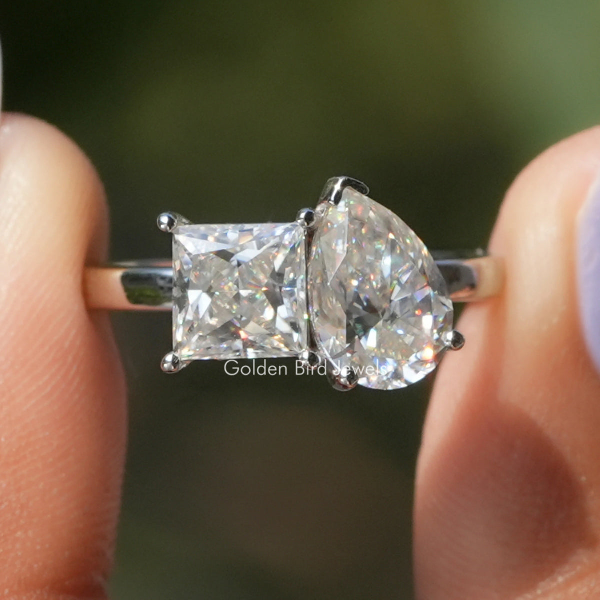 Two-stone toi et moi moissanite ring with princess and pear-cut clear stones