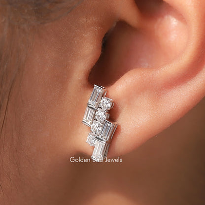 Silver-tone round and baguette moissanite stud earrings on ear