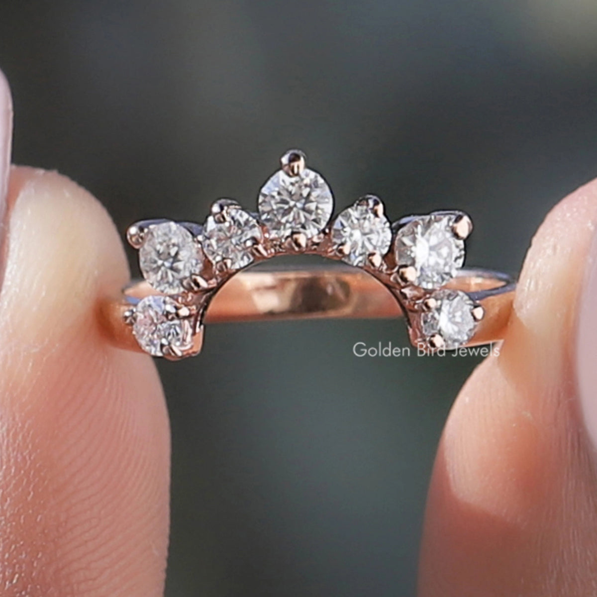 Curved stacking wedding band with multiple round diamonds in a clustered design