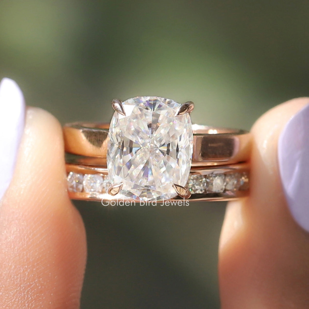 Gold-tone bridal ring set with cushion-cut colorless center stone and side accents