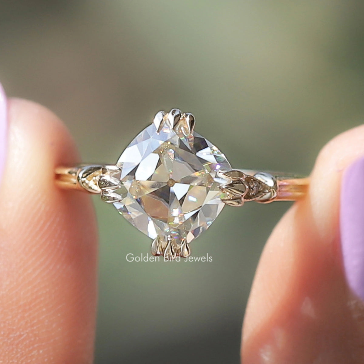 Cushion-cut moissanite ring in rose gold with four-prong center stone