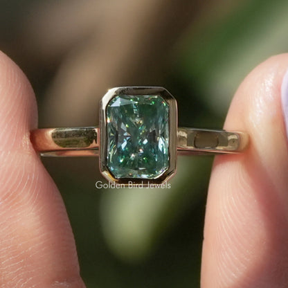 Bezel-set emerald-cut blue moissanite engagement ring, split metal band