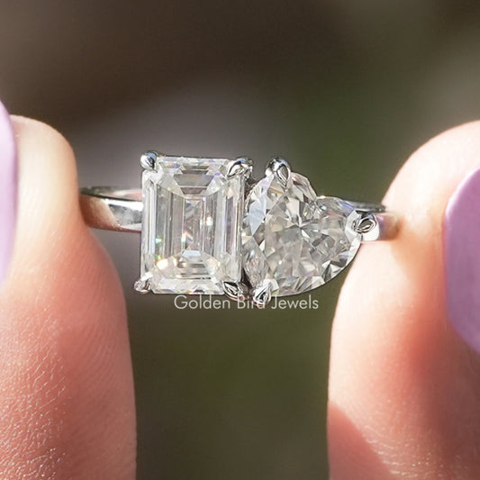 Toi et moi moissanite ring with emerald-cut and heart stones in prongs on silver band