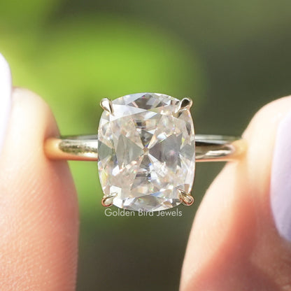 Cushion-cut solitaire moissanite ring with four-prong setting and metal band