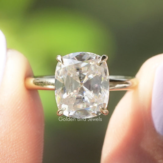 Cushion-cut solitaire moissanite ring with four-prong setting and metal band