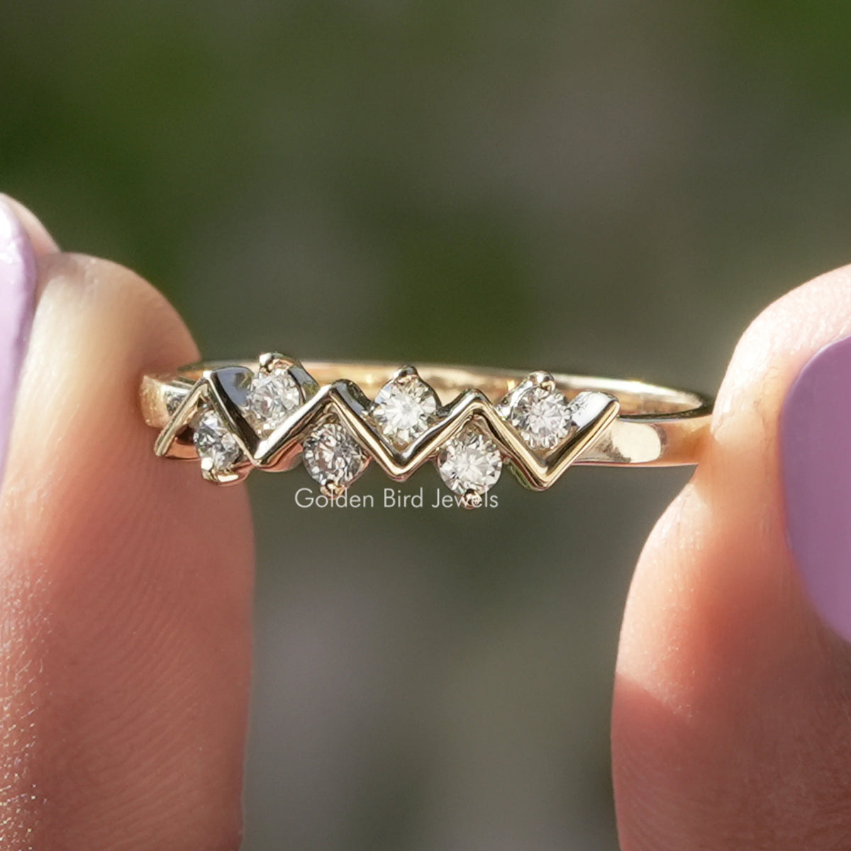 Gold-tone stacking eternity band with a zigzag row of round prong-set stones