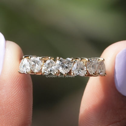 Top view of heart-cut moissanite half eternity band with evenly spaced stones