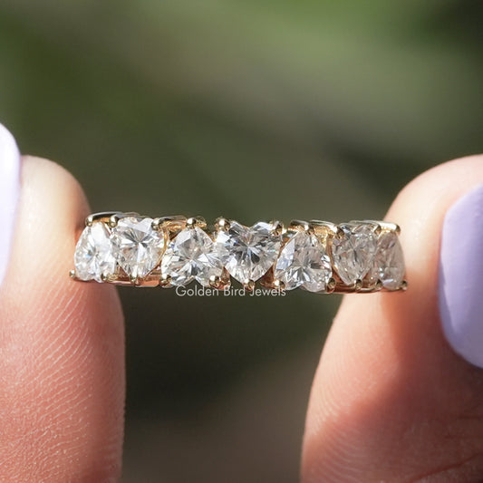 Top view of heart-cut moissanite half eternity band with evenly spaced stones