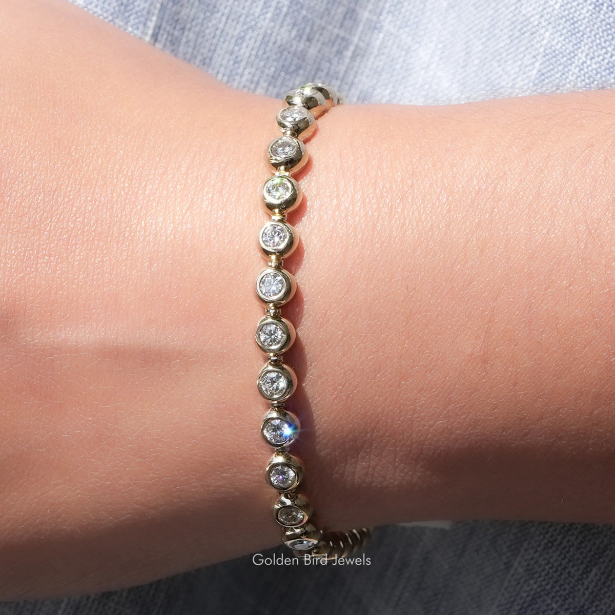 Moissanite bezel setting bracelet with round stones, wrist close-up detail