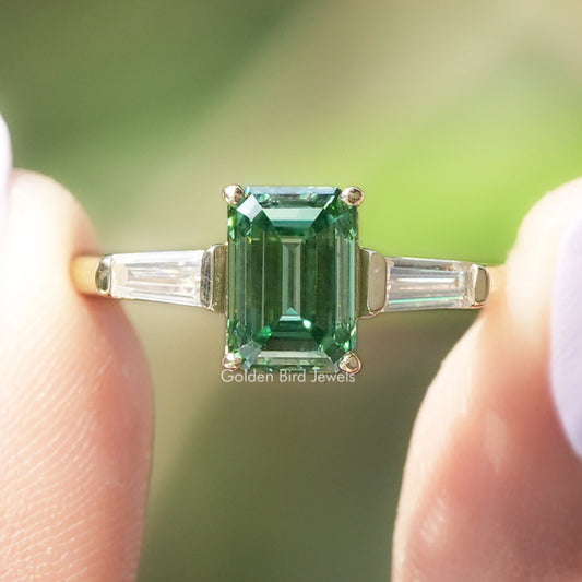 Emerald-cut green moissanite engagement ring with baguette side stones