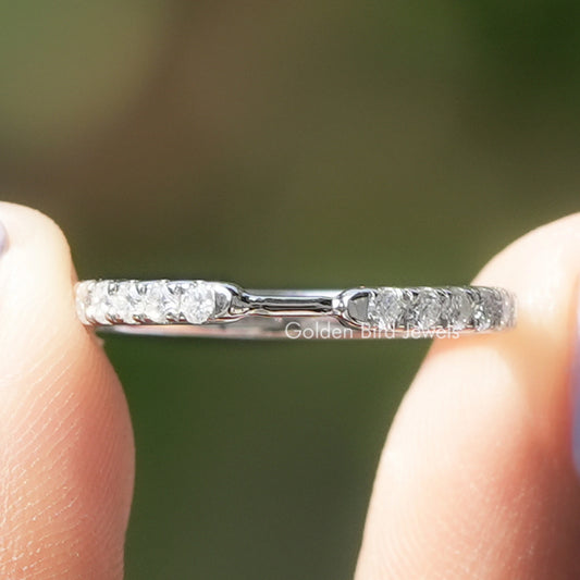 Close-up of white metal band with round diamonds and prong settings