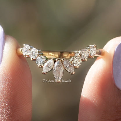 Close-up of marquise-cut moissanite stones on a curved gold stacking band