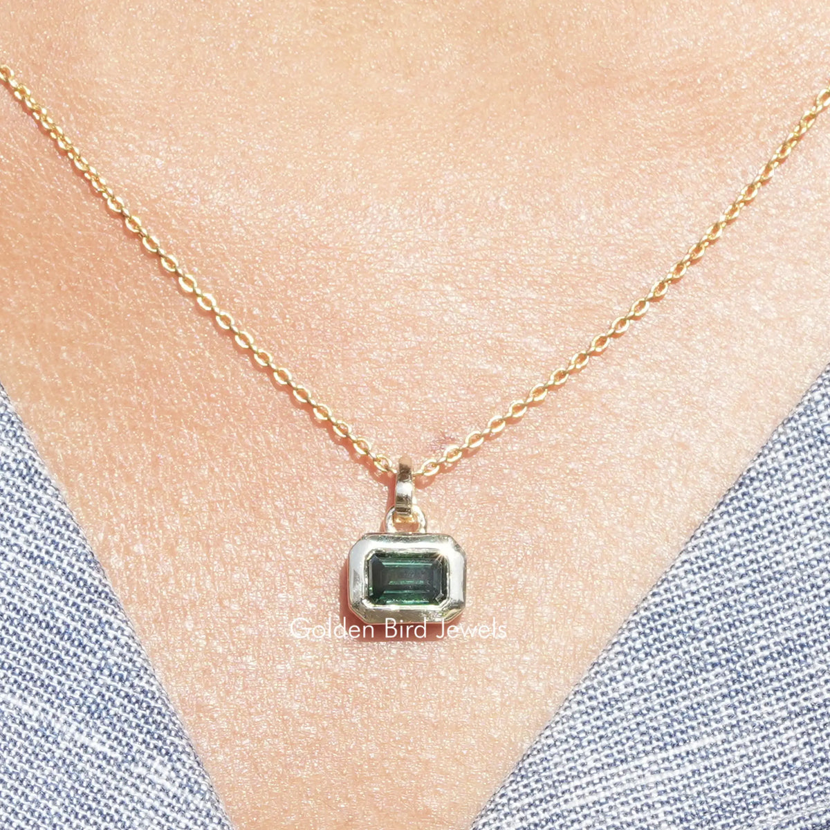 Green emerald-cut solitaire pendant with square moissanite on gold-tone chain