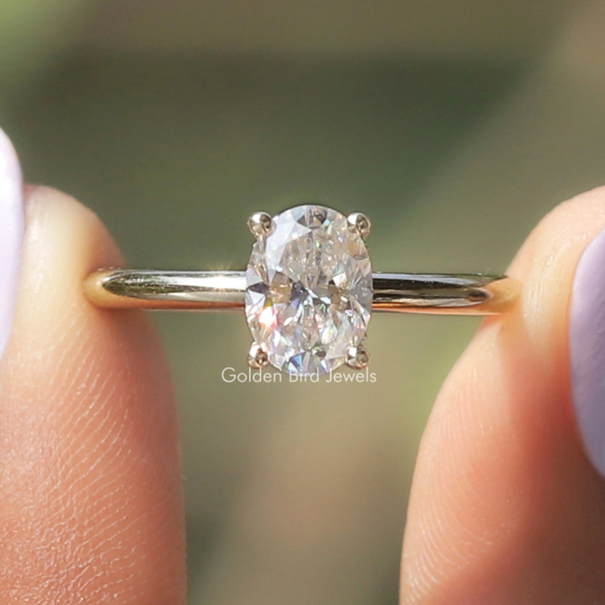 Oval moissanite hidden-halo ring with bright center stone on silver band